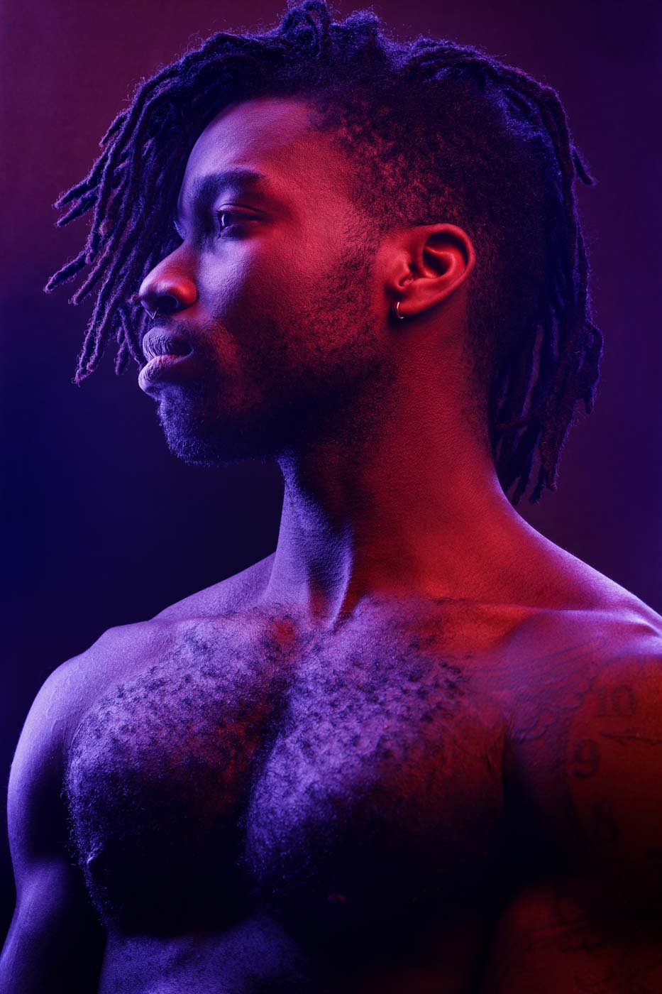 Artistic gel lighting portrait of Prince, illustrating creative use of light and color in model portfolios by John Gress Photography.