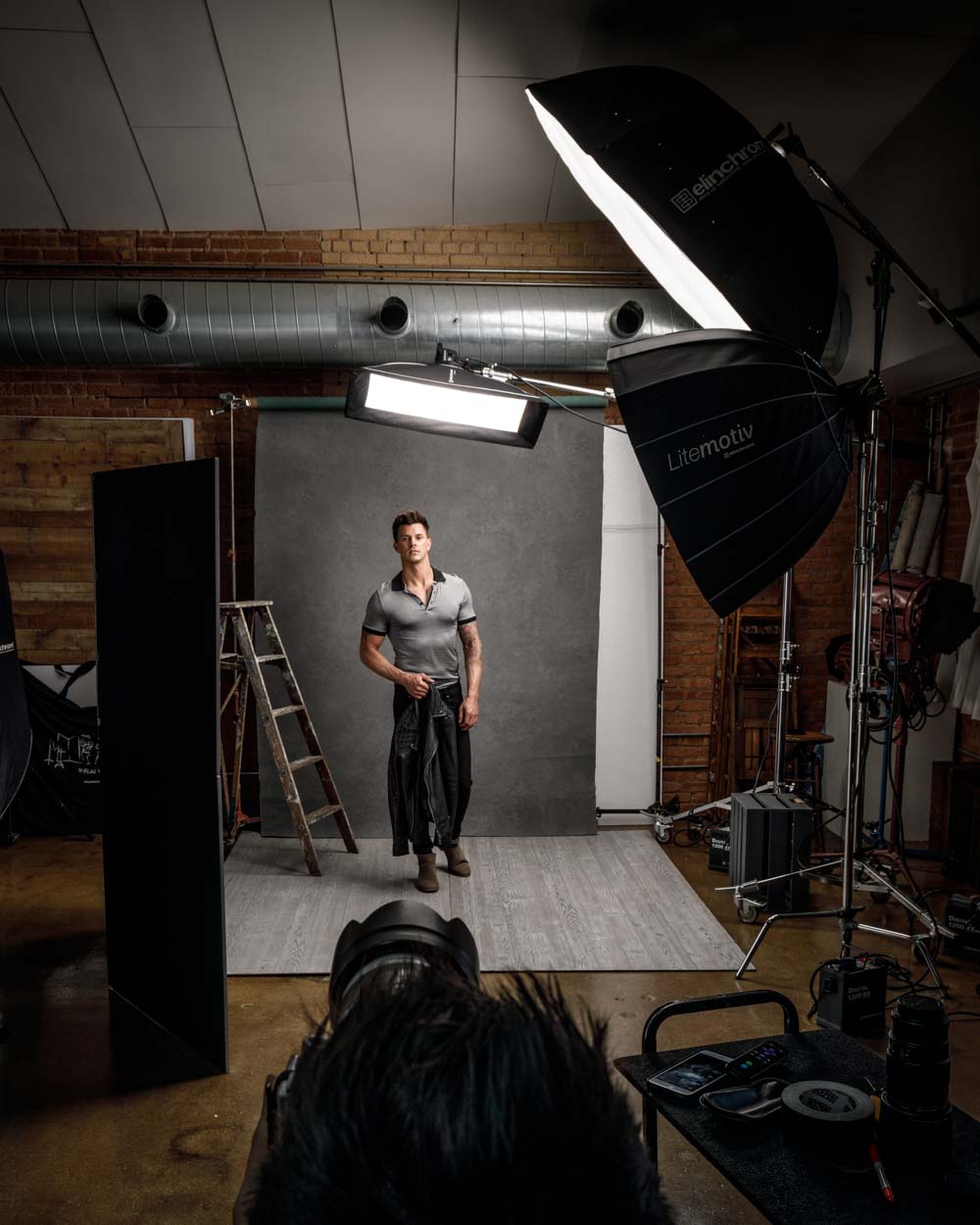 Behind the scenes image capturing the dynamic atmosphere of a professional model portfolio shoot in Chicago