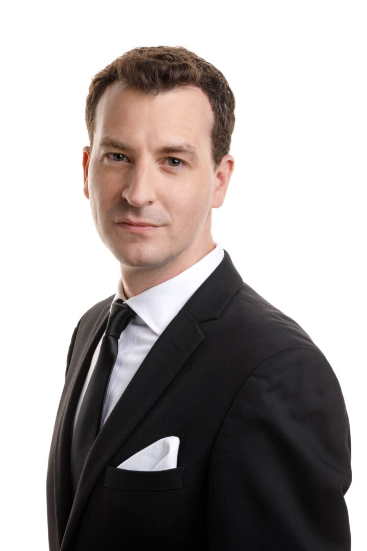 This side view headshot of Stephen in a black suit and white dress shirt captures a more introspective moment, suitable for roles requiring depth and complexity