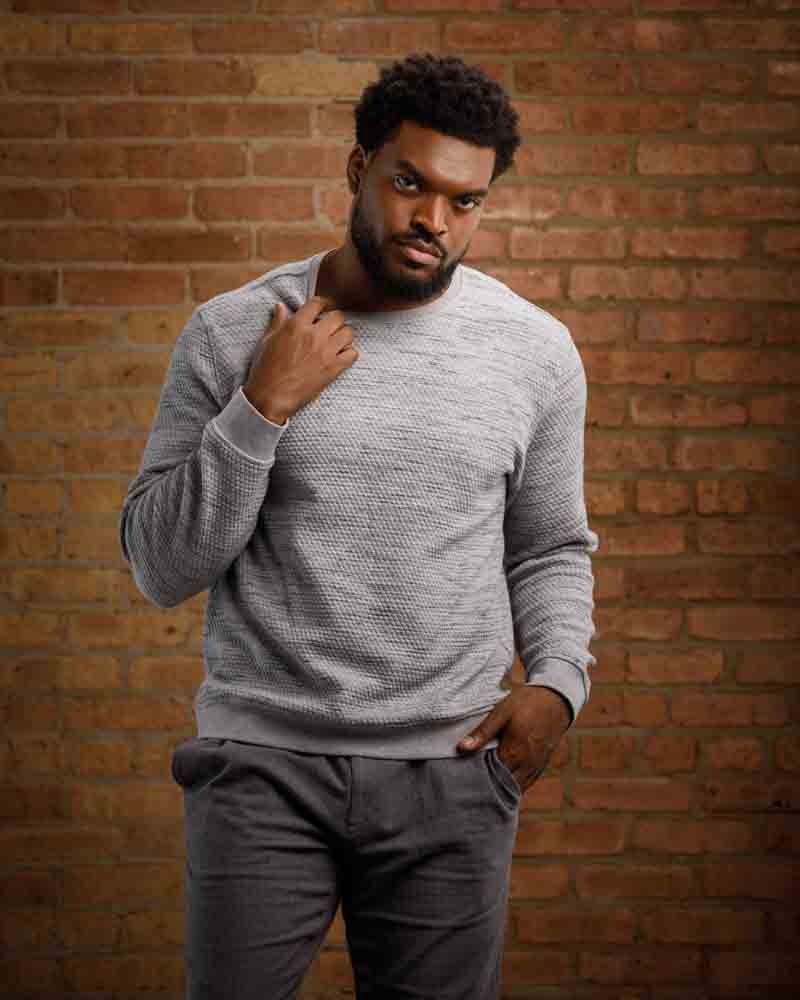 Plus size male model Mark W. in a stylish urban setting, reflecting versatility in acting and modeling headshots