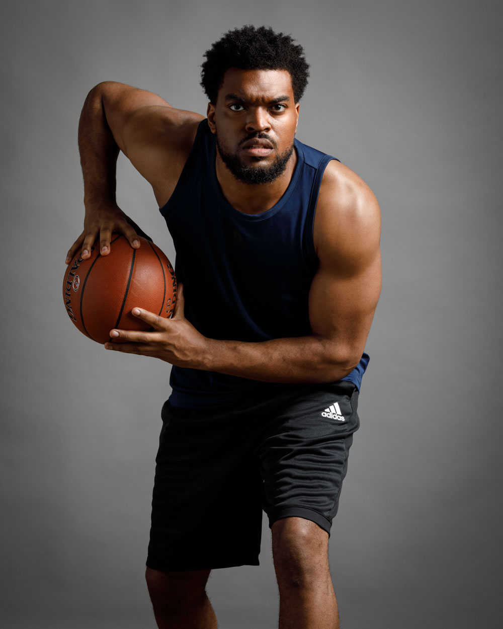 Big and tall model Mark W. as a basketball player, showcasing his fitness and agility, crucial for sports roles