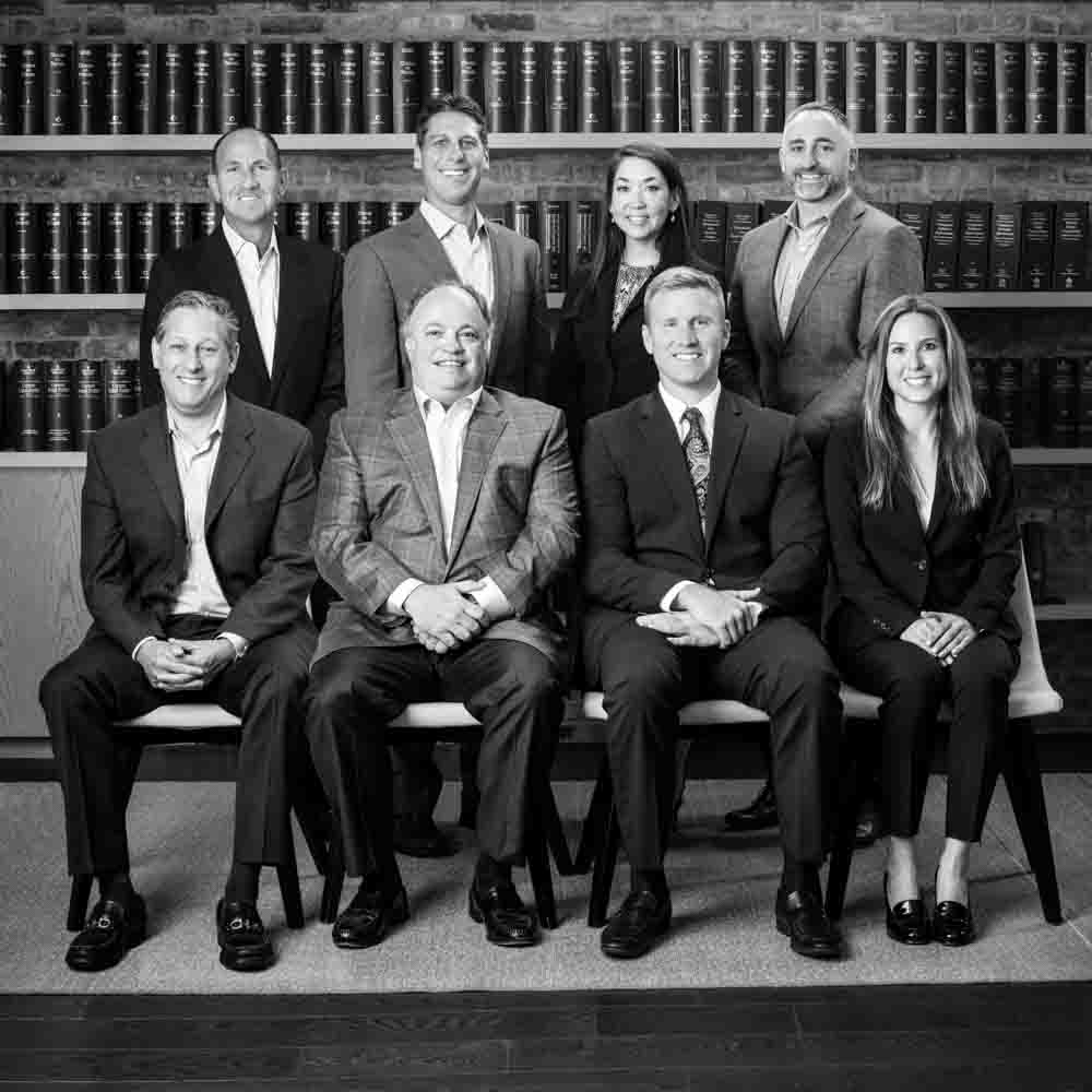 Group photo of attorneys in a law library
