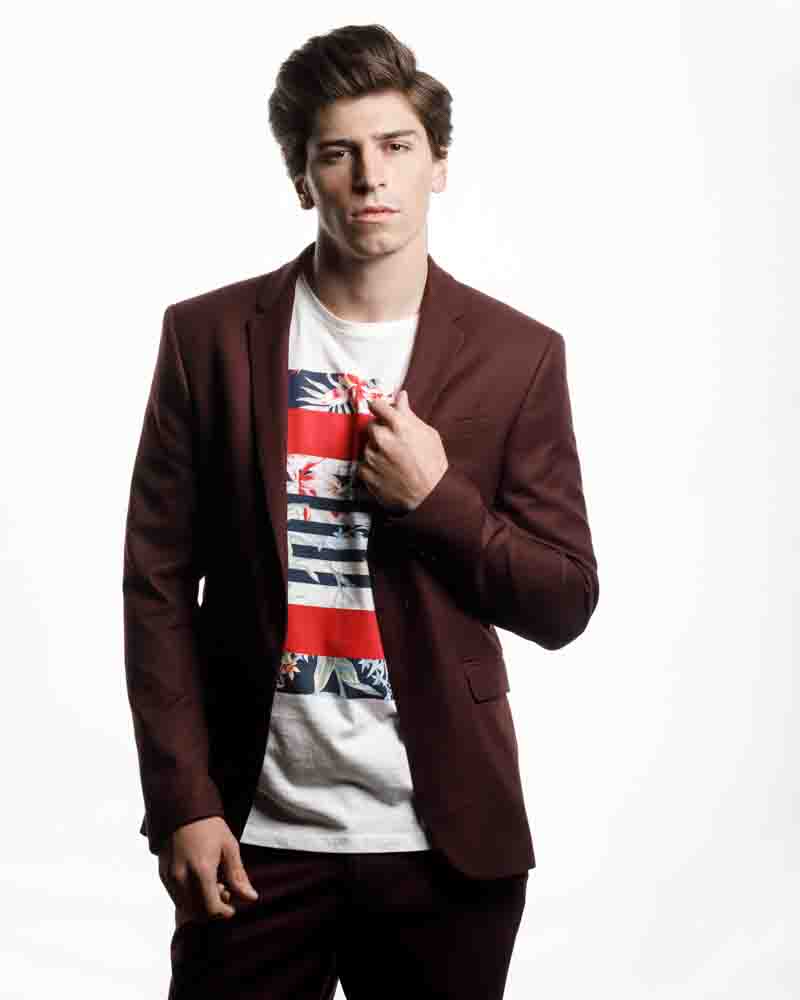 Noah in a maroon suit and white patterned t-shirt, offering a casual yet professional look.