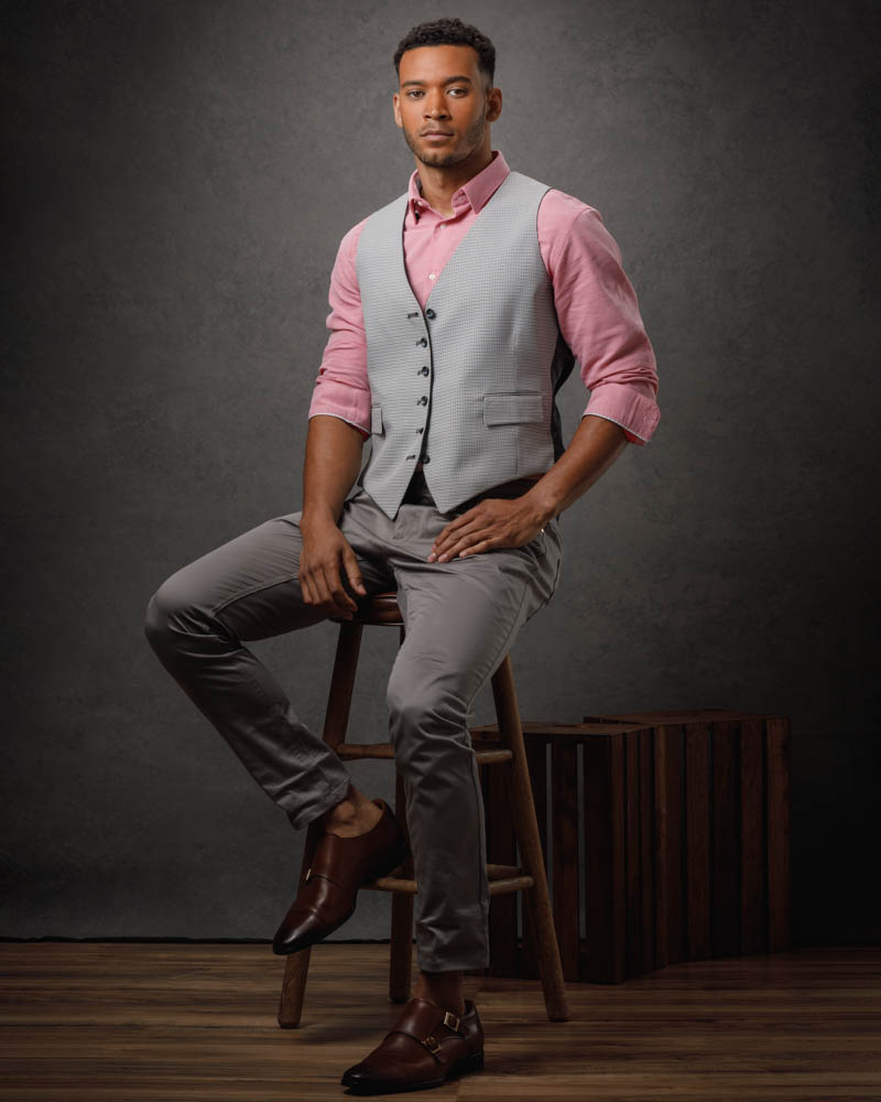 Full body portrait of male model Zane in Chicago, dressed in stylish gray and pink attire, perfect for professional headshots