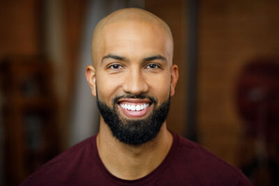 Headshot guidelines with David in studio with beard and glasses, professional look