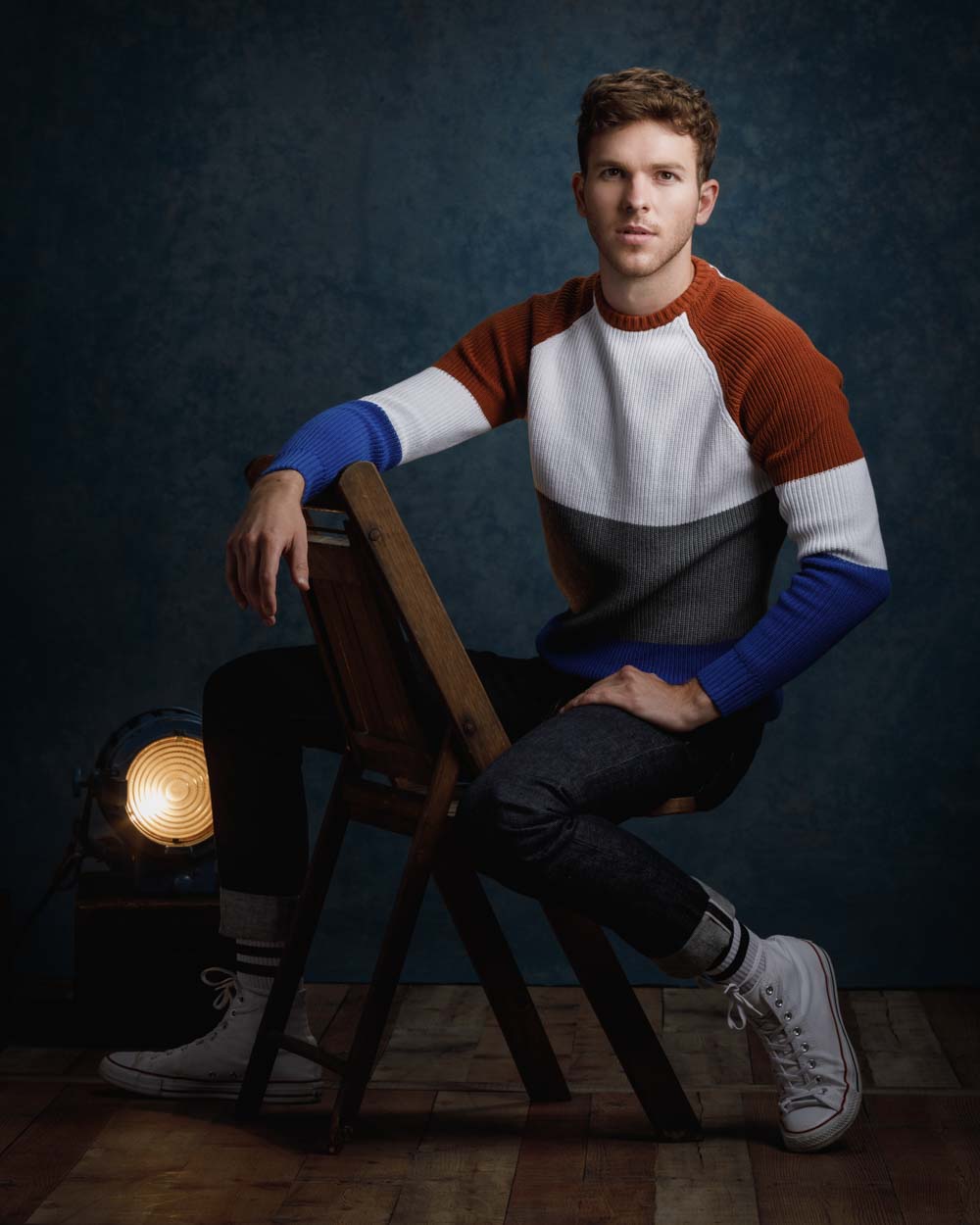 Connor seated backwards in an antique chair
