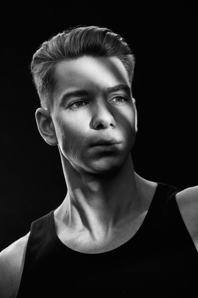 High contrast black-and-white portrait of Erik, showcasing his strong features and modeling potential