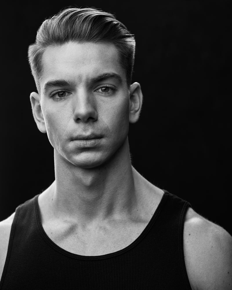 Chicago modeling portfolio photographer Close-up headshot of Erik in a black tank top, highlighting his intense and focused expression