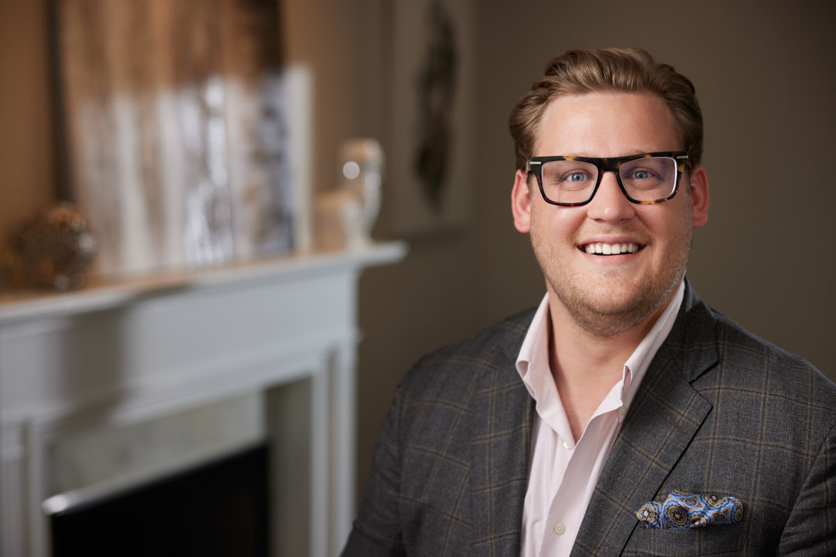 Evan from the reviews, posing confidently in a professional setting for his Chicago realtor headshots.