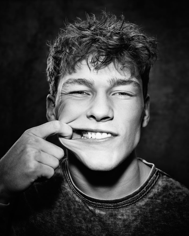 Professional portfolio photographer in Chicago - Evan in a black-and-white headshot, showing his playful side