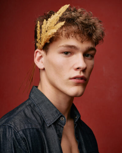 Professional portfolio photographer in Chicago - Evan wearing a jean jacket, unbuttoned with wheat behind his right ear