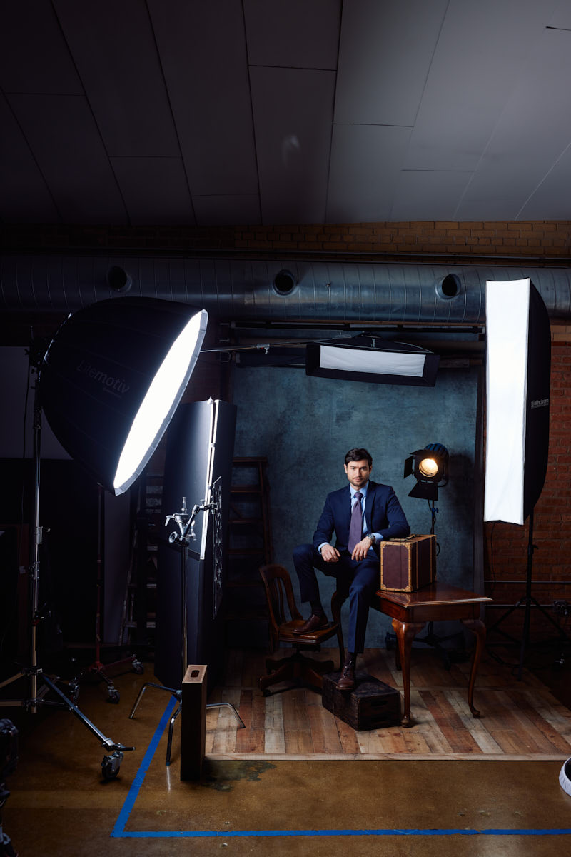 A behind-the-scenes look at the studio setup for the formal shot. This image provides context on the lighting and arrangement used to achieve the polished final portrait
