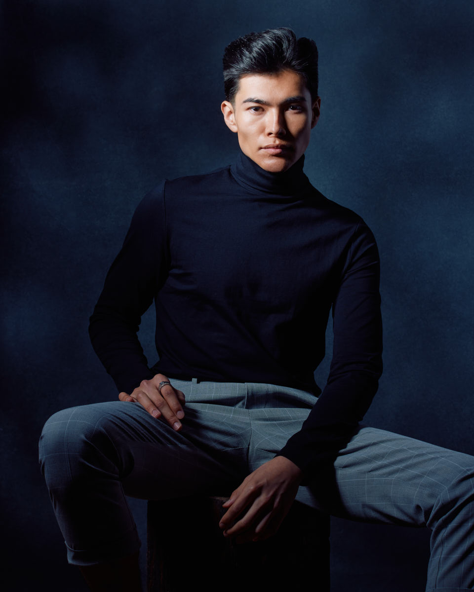 Become a Male Model in Chicago-Similar to the second image, Santiago is seated, but now he faces the camera directly with a confident and poised expression.