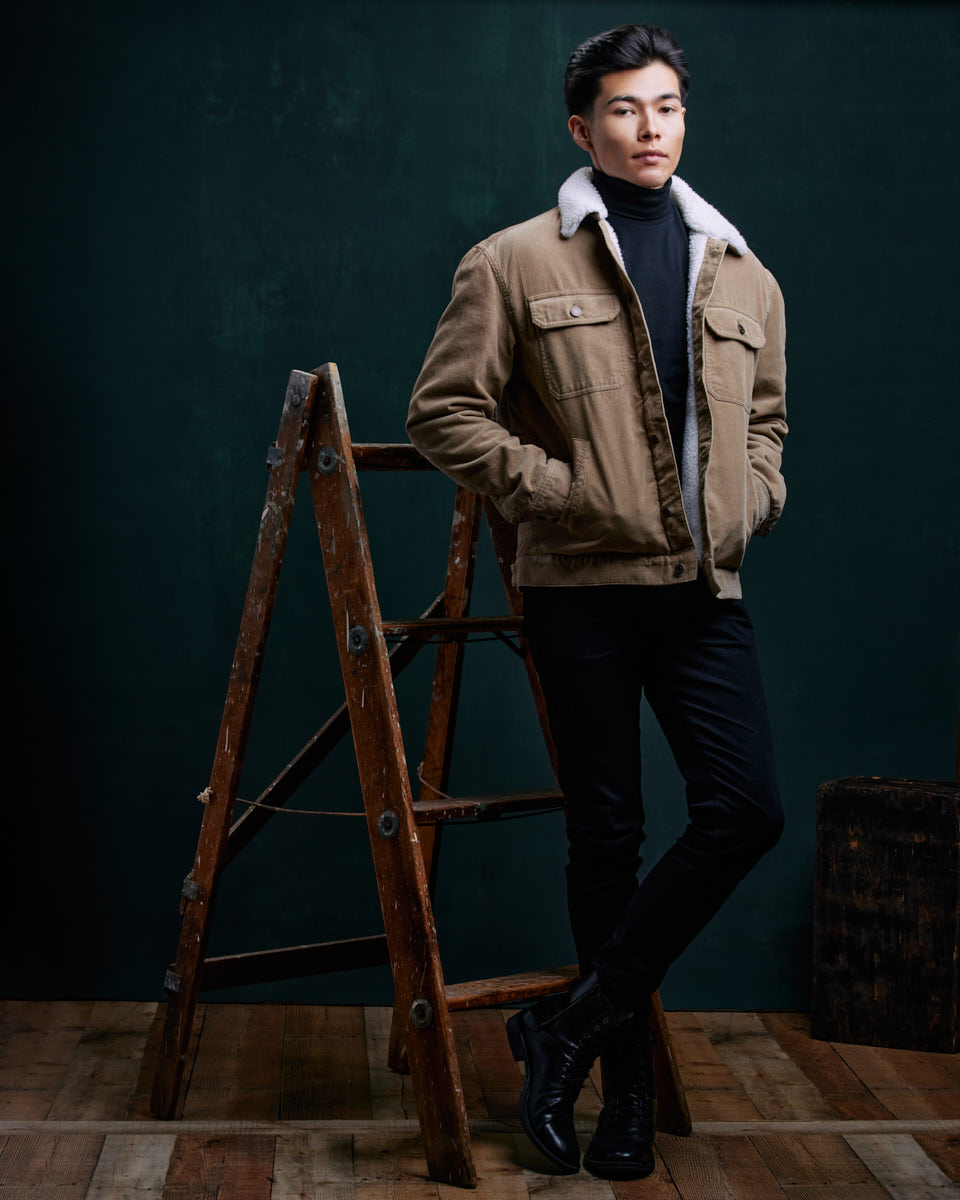 Become a Male Model in Chicago-Santiago is standing next to the ladder but with a slight change in posture, giving a different angle to his look.