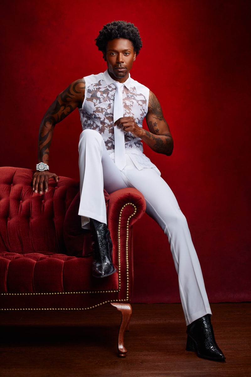Chris sits on a velvet couch during a high-fashion shoot in Chicago.