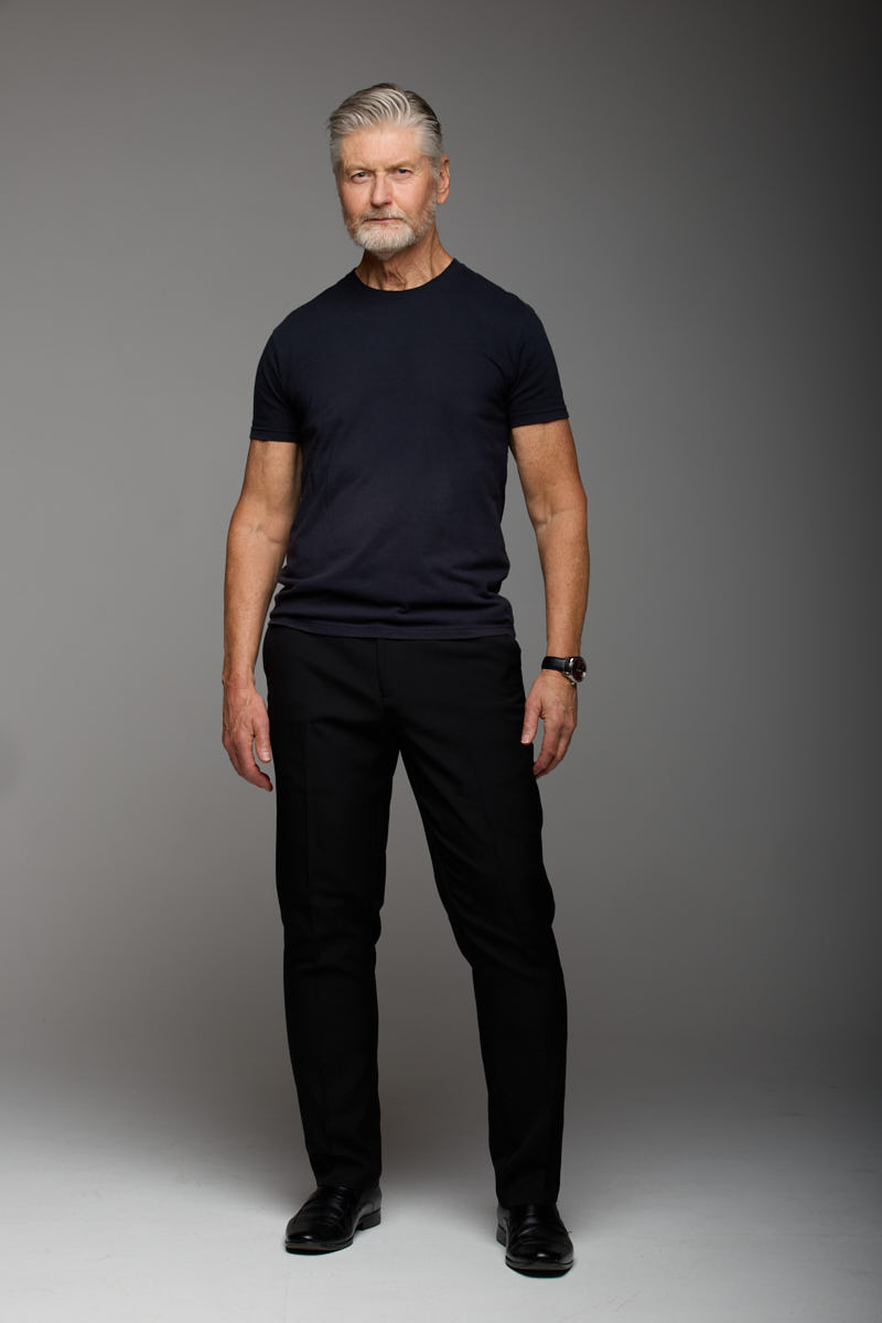 Full-length portrait of Jeff in a dark t-shirt and trousers.