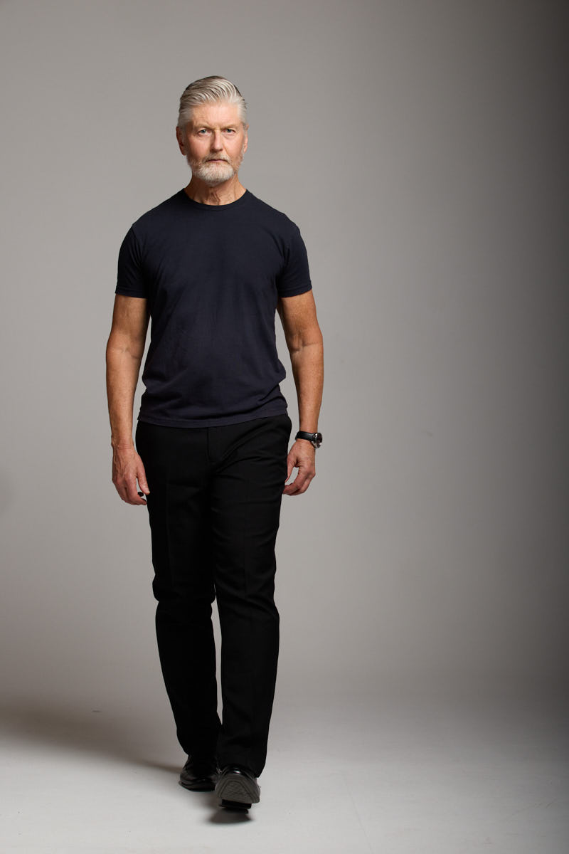 Walking pose of Jeff in casual black attire.