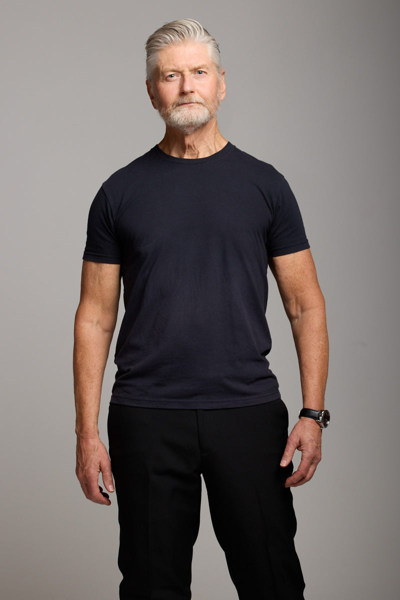 Mid-length portrait of Jeff standing straight.