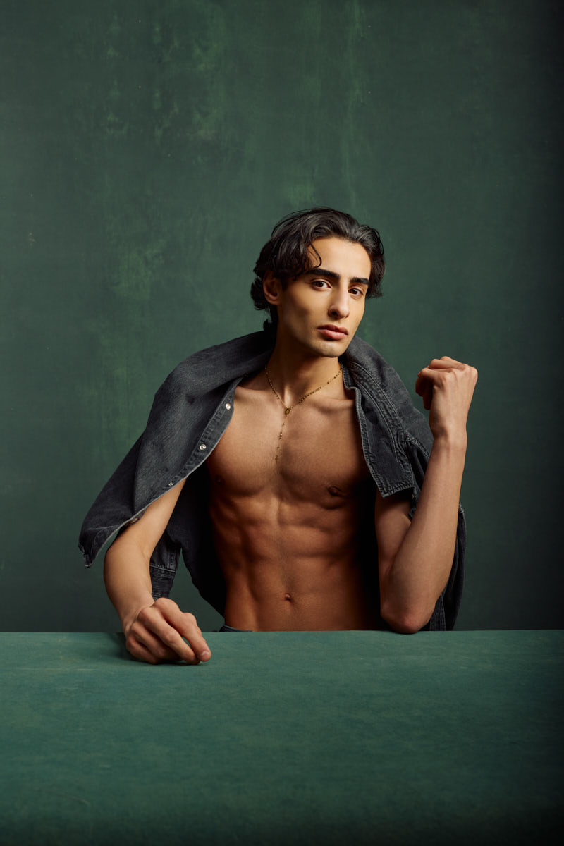 Giorgio wearing a denim jacket across his shoulders in an editorial portrait created for a Male Fashion model portfolio Chicago.