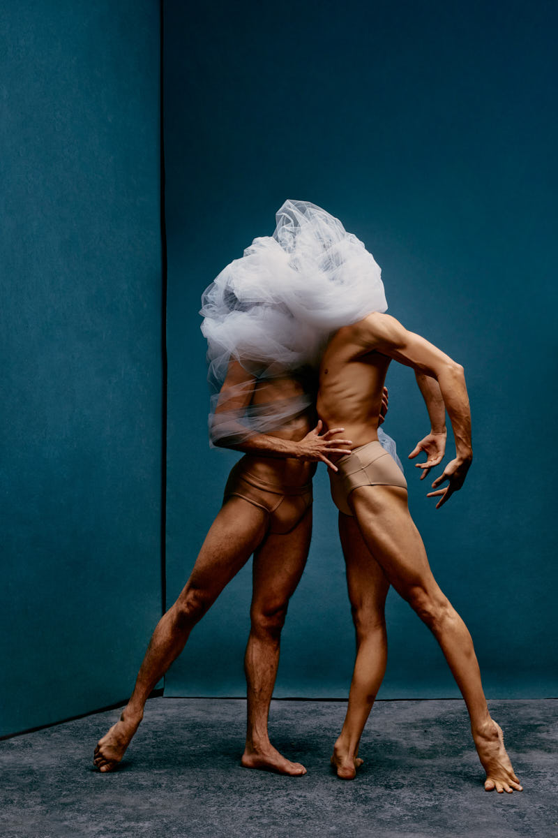 Ballet duet pose photographed in studio with stylized light