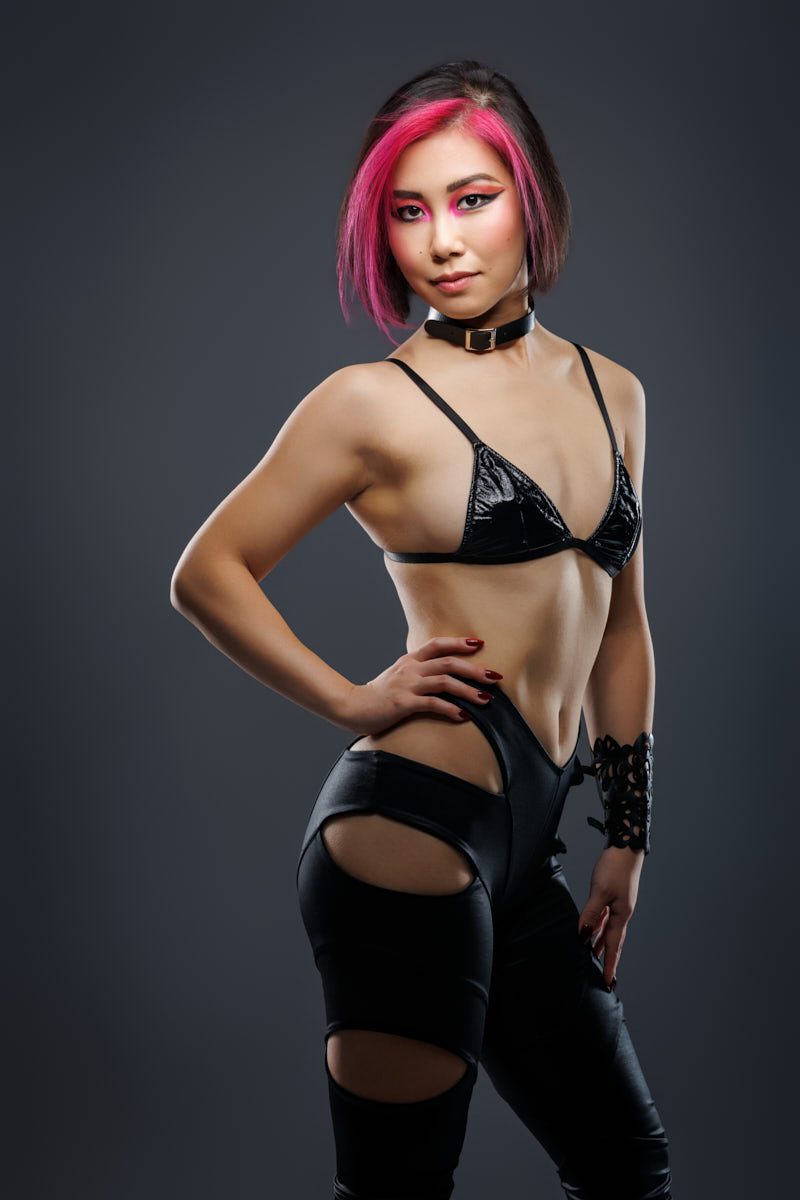 Refined Music marketing photography Chicagoo portrait of Tianqing in black styling against a dark gray background