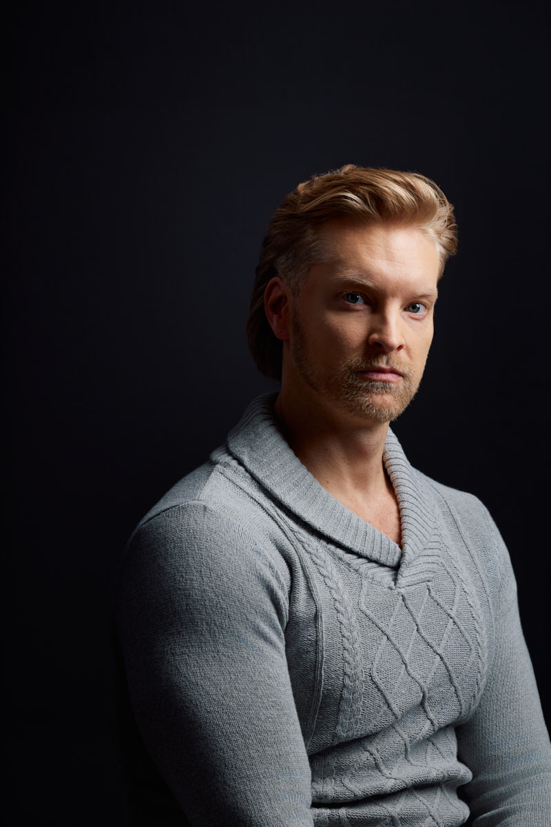 Nick appears within dramatic negative space during an editorial portrait session in Chicago