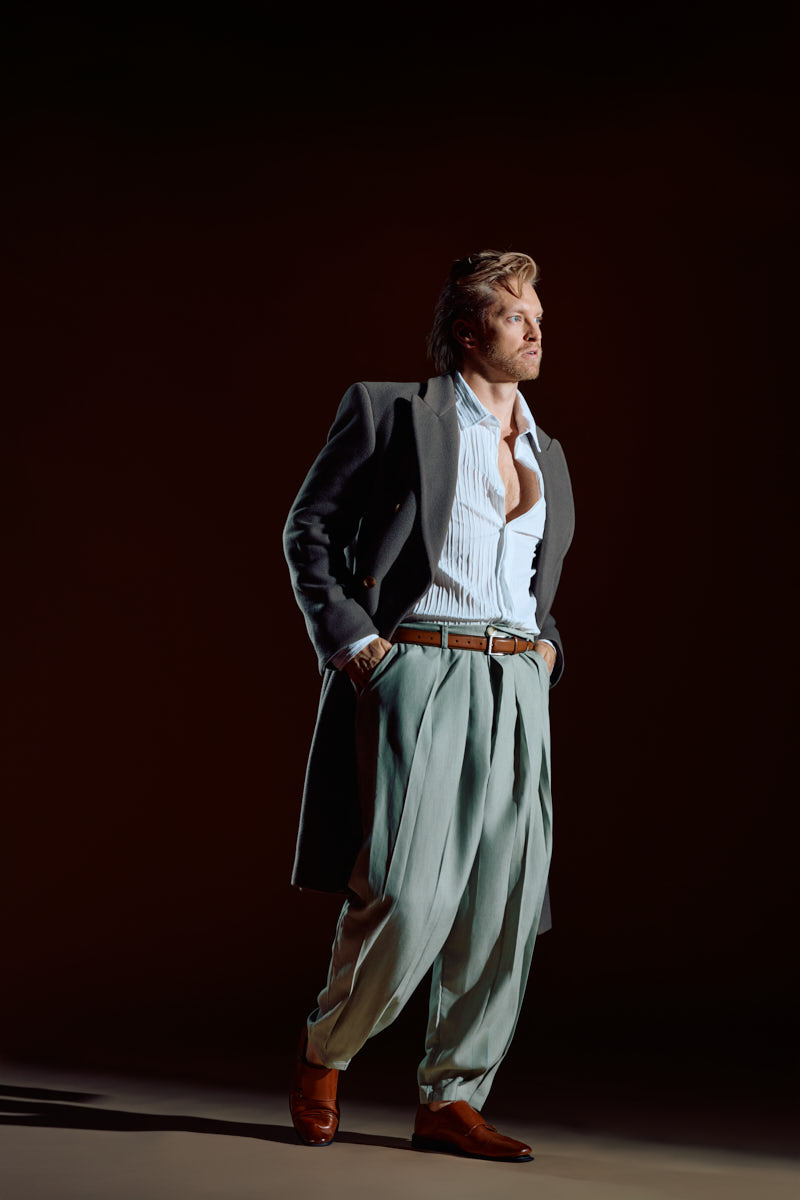 Editorial headshot photographer in Chicago photographs Nick in an oversized coat, white shirt, and sage trousers