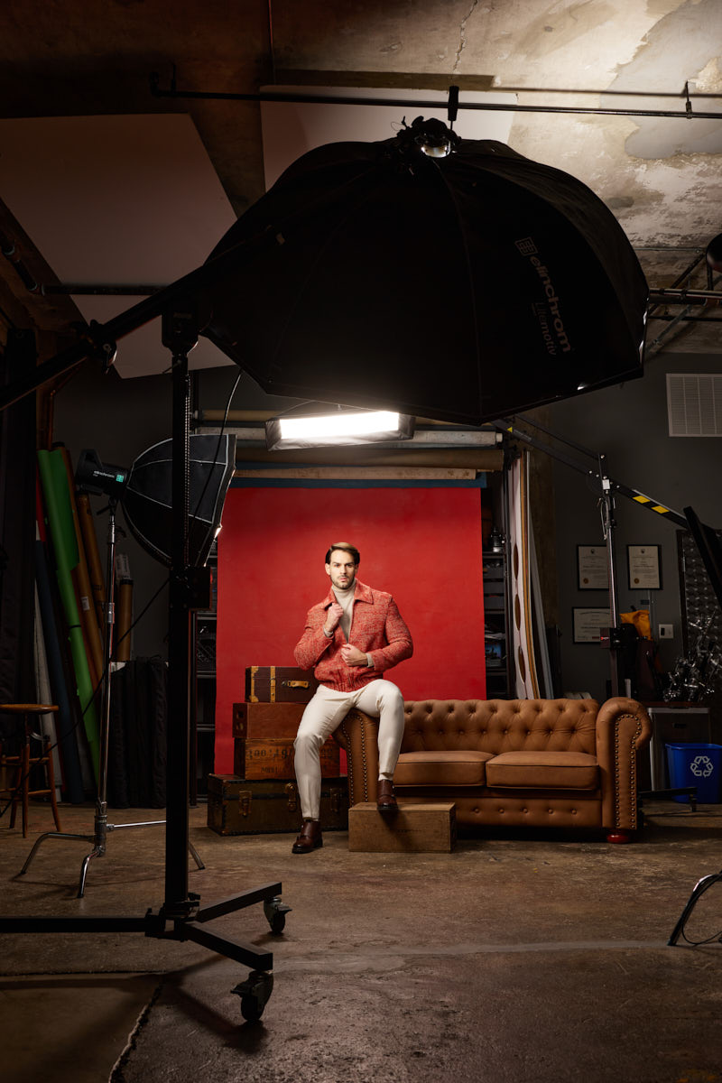 Athletic model photographer Chicago behind-the-scenes view showing Jamie, the red set, and a large professional flash modifier.